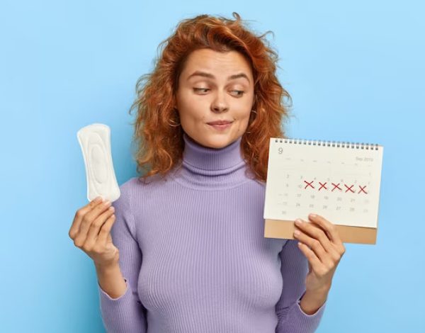 photo-young-woman-looks-period-calendar-checks-menstruation-days_273609-30253
